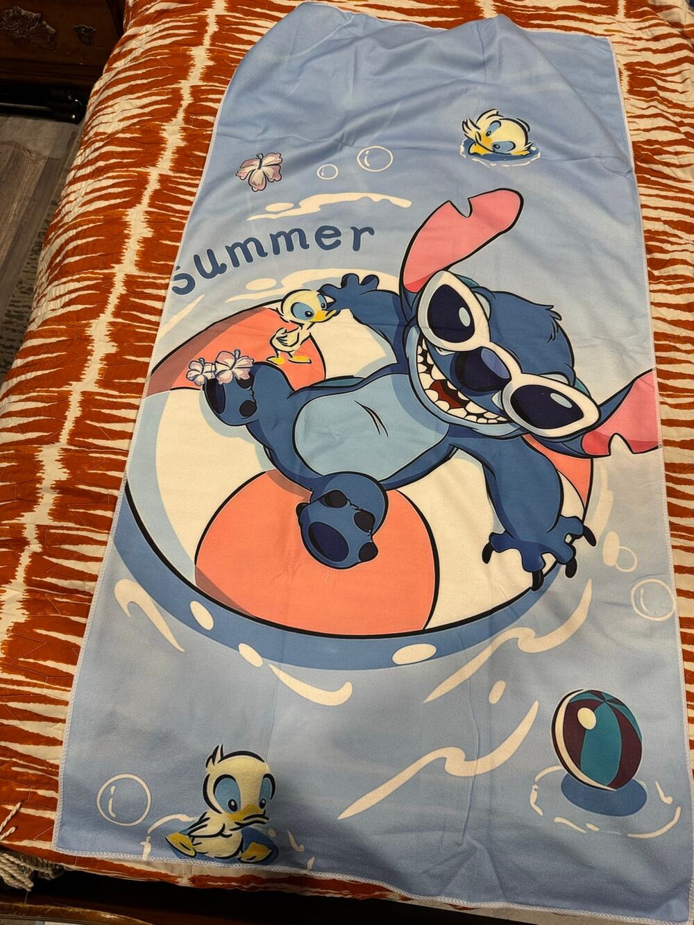Stitch beach towel with Stitch wearing sunglasses on a live saver'